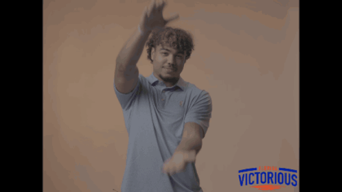 Man in Blue Shirt with Victorious