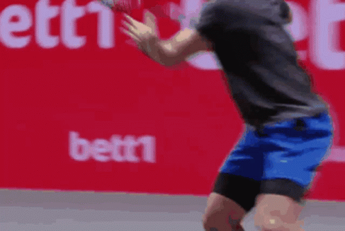 Man In Blue Shorts Playing Tennis GIF