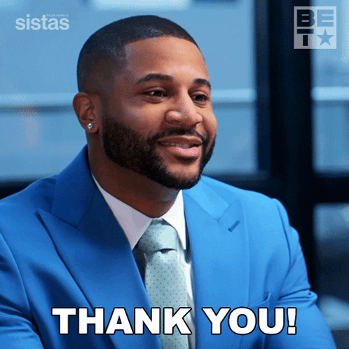 Man in Blue Suit and Tie Says Thank You
