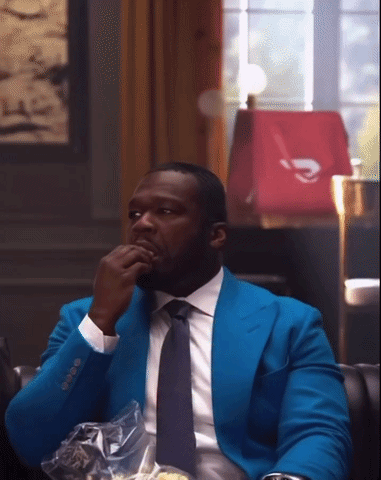 Man in Blue Suit and Tie Sitting