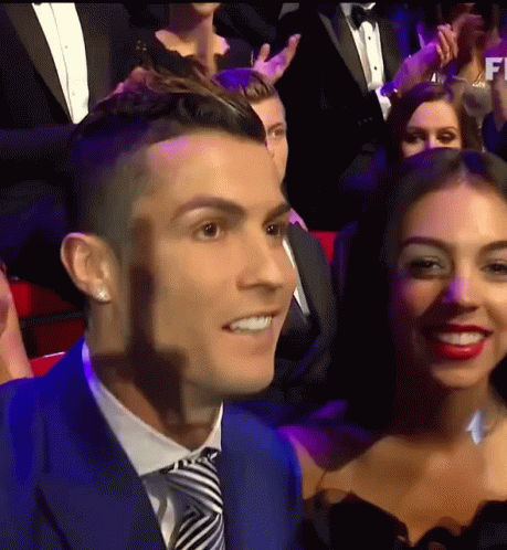 Man in Blue Suit and Tie Smiling Next to Woman