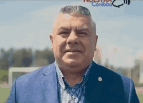 Man In Blue Suit At Nuestra Cordoba Sign GIF