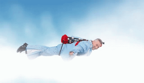 Man in Blue Suit Flying With Red Bag