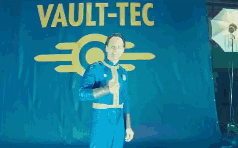 Man in Blue Suit Giving Thumbs Up Saying Vault Lc