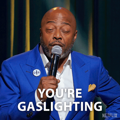 Man in Blue Suit Holding Microphone Saying You're Gaslighting
