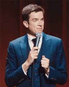 Man in Blue Suit Holding Microphone