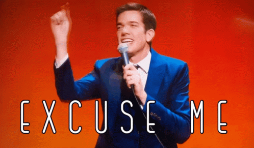 Man In Blue Suit Holding Microphone With Excuse Me GIF