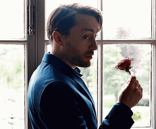 Man In Blue Suit Holding Rose GIF