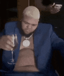 Man in Blue Suit Holding Wine and Smoking Cigarette