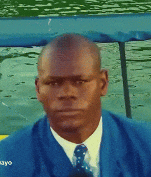 Man in Blue Suit Looking at Camera Saying Ayo