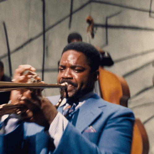 Man in Blue Suit Playing Trumpet