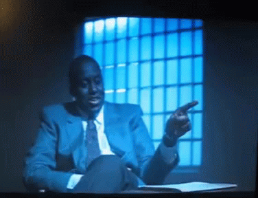 Man in Blue Suit Pointing