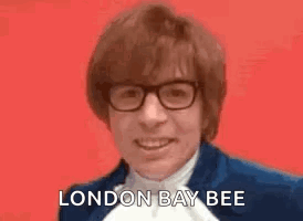 Man in Blue Suit Smiling Saying London Bee