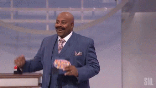 Man in Blue Suit With Family Feud Sign