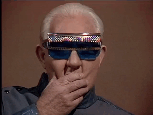 Man in Blue Sunglasses Covering Mouth