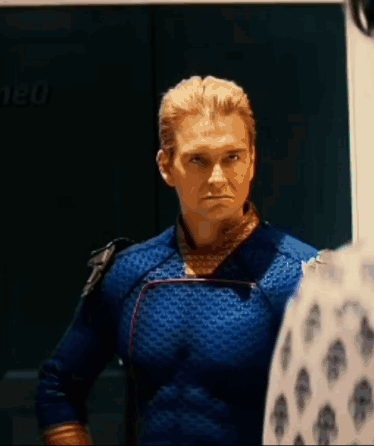 Man in Blue Superhero Costume Standing Next to Man in White Shirt