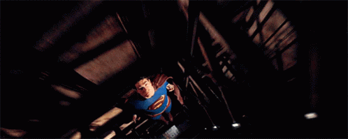Man in Blue Superman Costume Flying