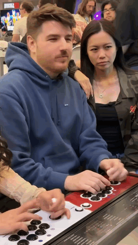 Man in Blue Supreme Hoodie Playing Video Game