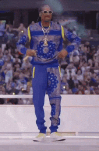 Man in Blue Sweater and Pants in Front of Crowd