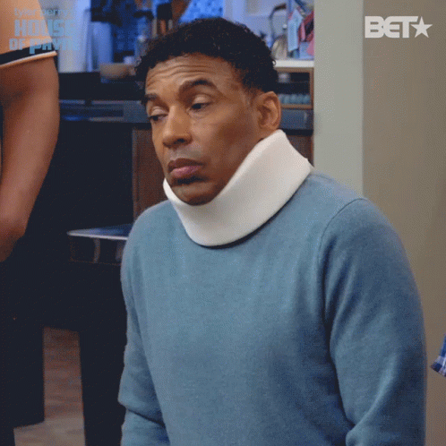 Man in Blue Sweater and White Neck Brace With BET Logo