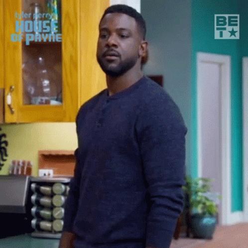Man in Blue Sweater in Kitchen With House of Payne