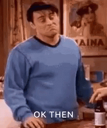 Man in Blue Sweater Making a Face