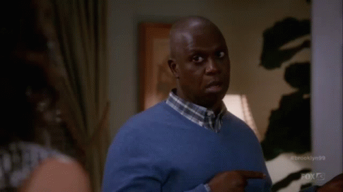 Man In Blue Sweater Pointing To Oh GIF