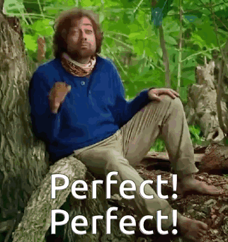 Man in Blue Sweater Sitting on Tree Trunk