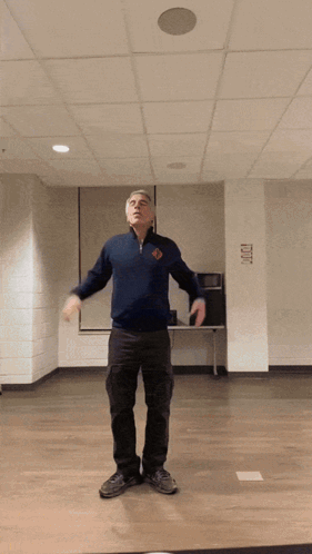 Man in Blue Sweater With Exit Sign