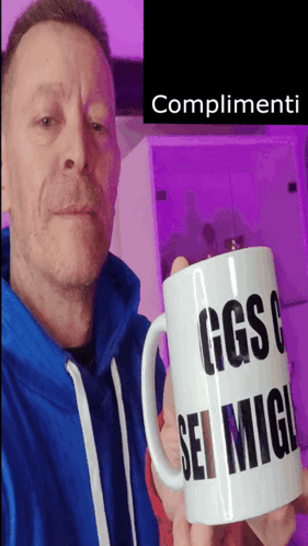 Man In Blue Sweatshirt Holding Mug Saying Complimenti GIF