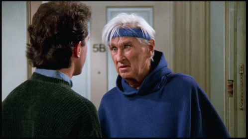Man in Blue Sweatshirt Talking to Man