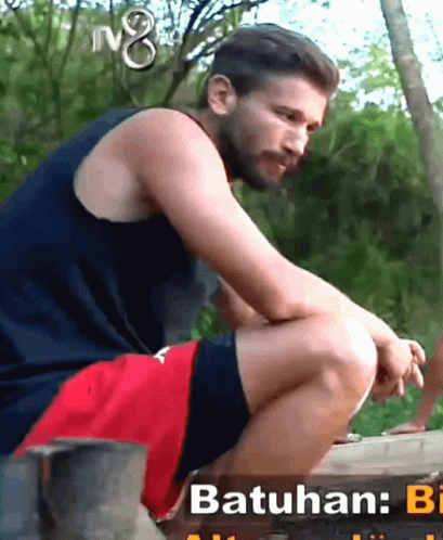 Man in Blue Tank Top and Red Shorts