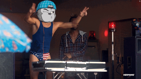 Man in Blue Tank Top and Red White Blue Trunks Dancing at Brother Keyboard