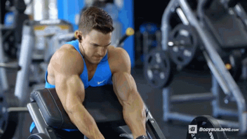 Man in Blue Tank Top Lifting Weights