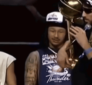 Man in Blue Thunder Jersey Holding Trophy