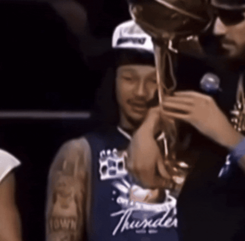 Man in Blue Thunder Jersey Holding Trophy