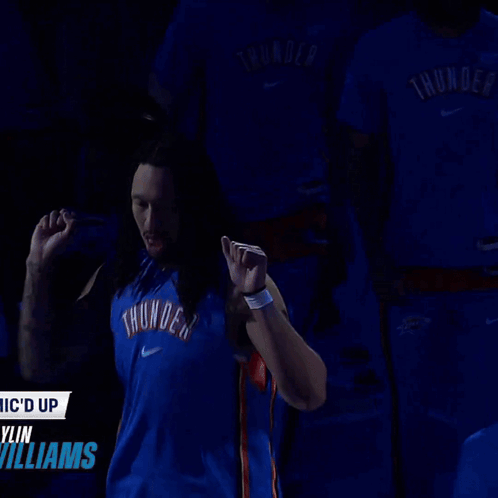 Man in Blue Thunder Jersey in Front of Williams Sign