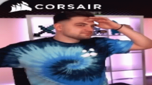 Man in Blue Tie Dye Shirt in Front of Corsair Logo