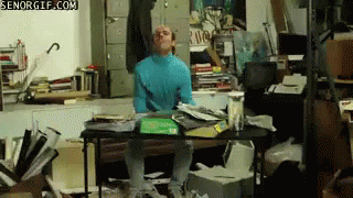 Man In Blue Turtleneck At Messy Desk senorgif.com