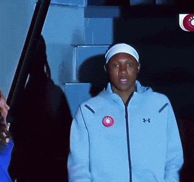 Man In Blue Under Armour Jacket In Front Of Stairs GIF