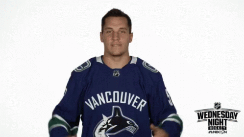 Man in Blue Vancouver Jersey Pointing to Chest
