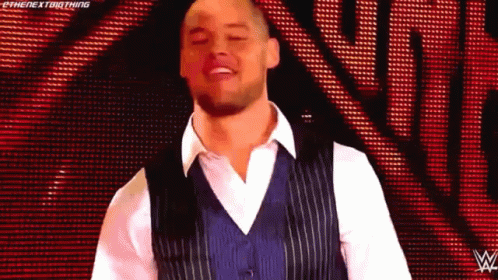 Man In Blue Vest And White Shirt On Red Background GIF