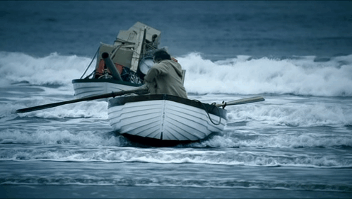Man In Boat Carrying Boxes GIF