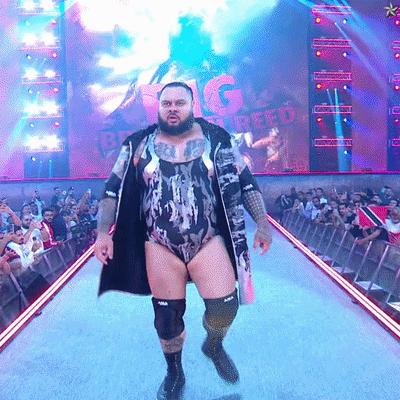 Man in Bodysuit Walking Runway With Big Creed Screen
