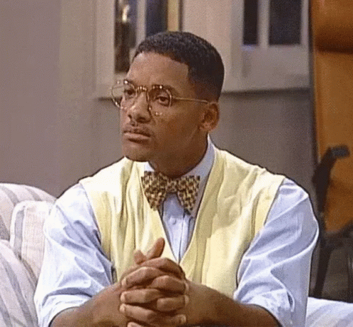 Man in Bow Tie and Glasses Sitting on Couch