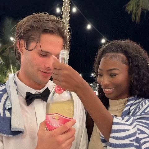 Man in Bow Tie Holding Love Island Champagne