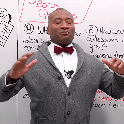 Man In Bow Tie With Bonus Questions Board GIF