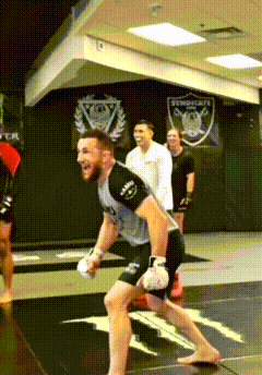Man in Boxing Gloves Running on Gym Mat