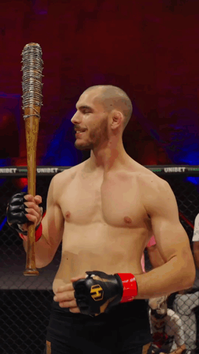 Man in Boxing Ring Holding Spiked Baseball Bat