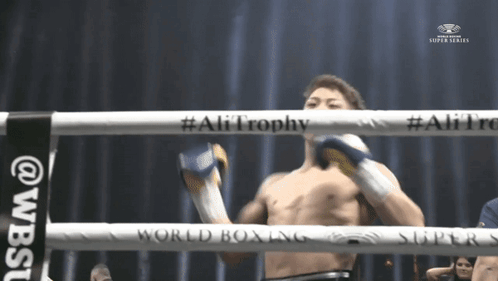 Man In Boxing Ring With Ali Trophy GIF